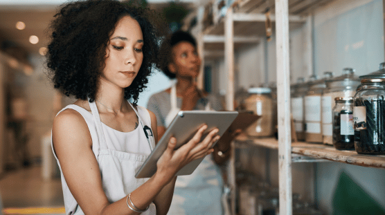 Person using AI on their tablet to manage inventory