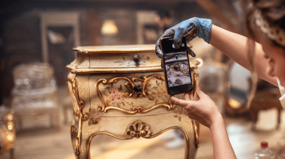 Payroll for retailers Antique shop owner taking pictures of her inventory.