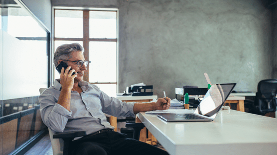 Startup founder in office talking on phone