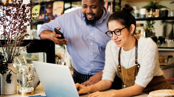 End of Year Small Business Checklist Business owners using their laptop and prepping their business for the new year