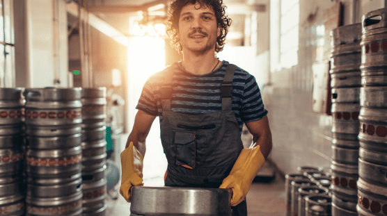 Cider maker carrying a keg in his cidery