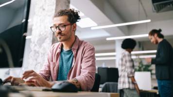 Man working on computer at startup.
