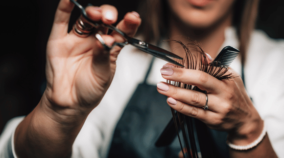 Hair salon owner cutting a client's hair.