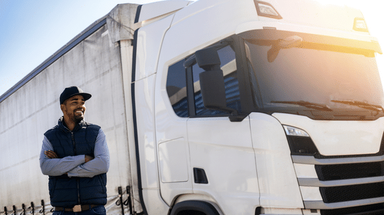 Proud truck company owner looking at the trucking empire he has built.
