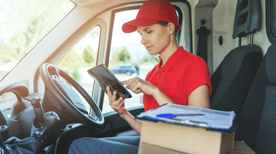 Female delivery driver checking her route